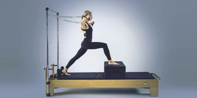 Girl in Pilates Reformer with Tower | Pilates Reformers with Tower